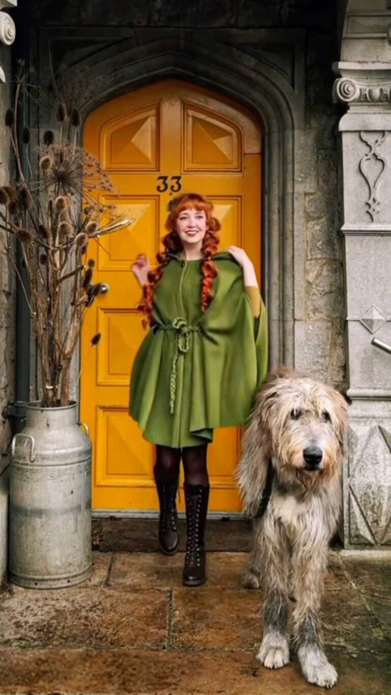 Rebecca wears Cape Philomena in the color moss green