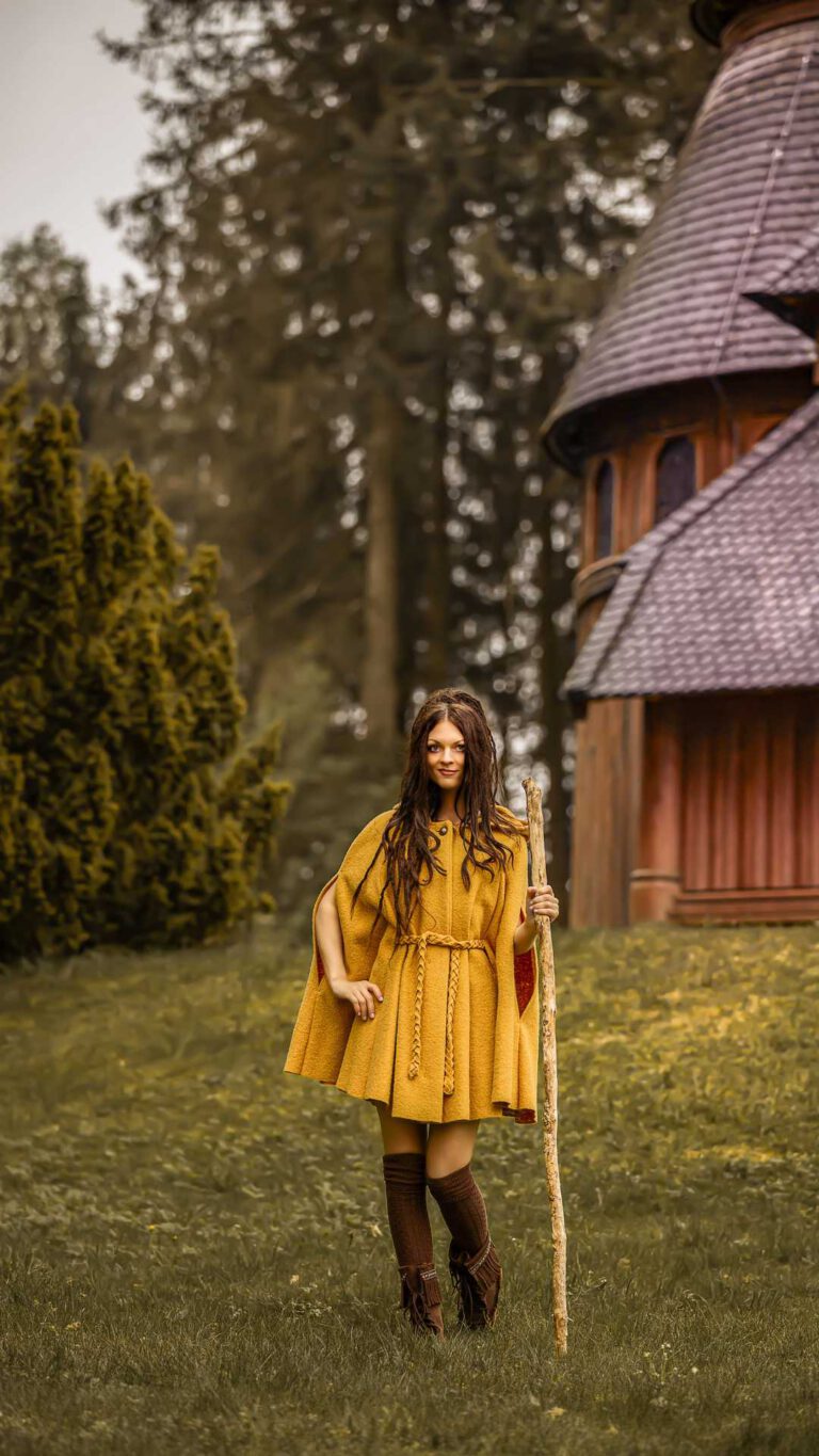 Natalie; Size: 1,70m, Clothing size 36) wears Cape Philomena in the color mustard